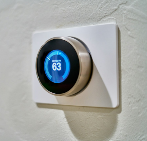 A smart thermostat set to 63 degrees.